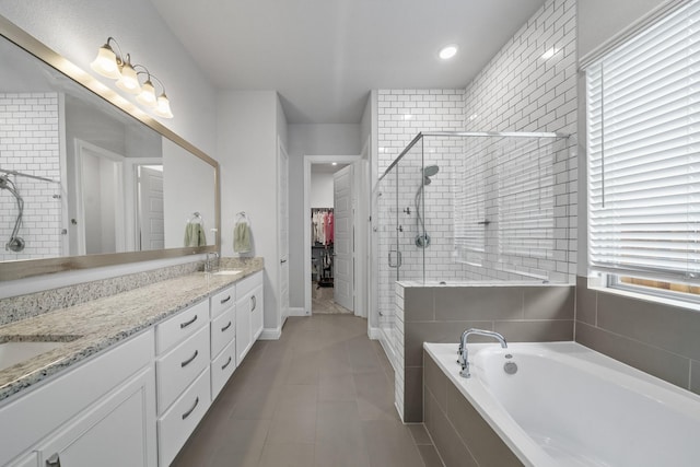 4381 Victoria Pine Dr, Spring, TX 77386 - bathroom featuring a stall shower, a bath, a spacious closet, double vanity, and tile patterned flooring