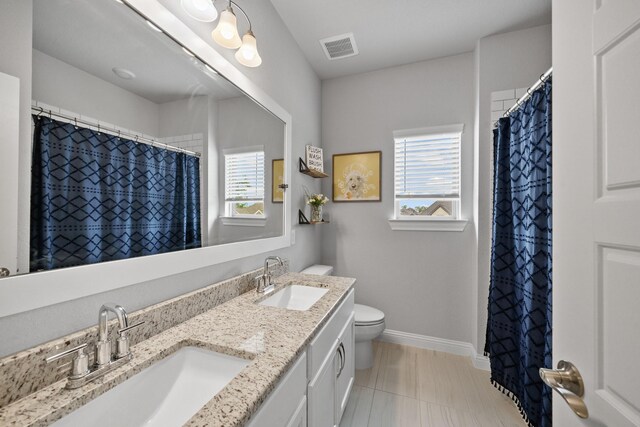 4381 Victoria Pine Dr, Spring, TX 77386 - full bathroom with plenty of natural light, toilet, baseboards, and double vanity