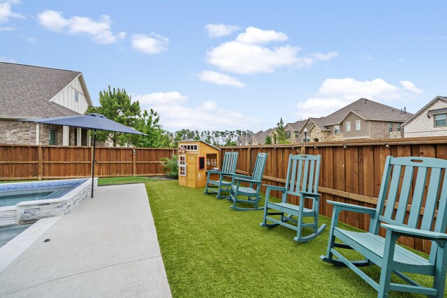 4381 Victoria Pine Dr, Spring, TX 77386 - view of yard featuring a residential view, a storage unit, an outdoor structure, a patio, and an outdoor hot tub