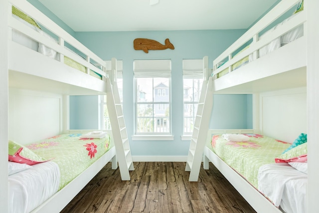 bedroom featuring baseboards and wood finished floors