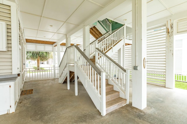 stairs featuring unfinished concrete floors