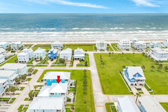 birds eye view of property featuring a beach view, a water view, and a residential view
