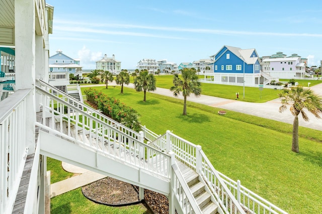 view of home's community with a lawn and a residential view