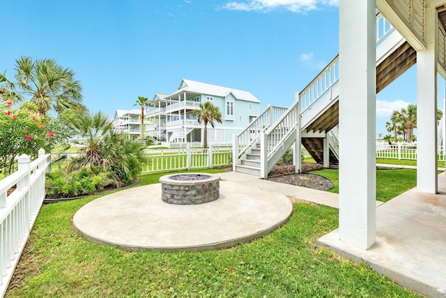 view of patio / terrace featuring stairs, a fenced backyard, and an outdoor fire pit
