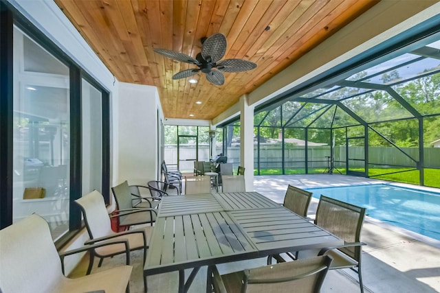 sunroom / solarium with a ceiling fan and outdoor dining area