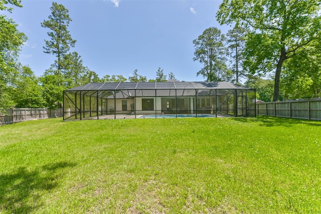 view of yard with a fenced backyard, a fenced in pool, and a lanai