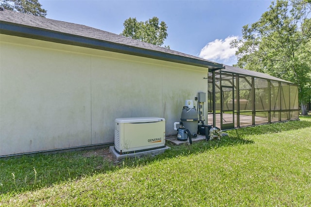 view of side of property with a yard, stucco siding, and glass enclosure