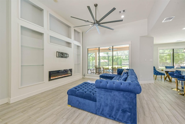 living area featuring ceiling fan, baseboards, visible vents, and wood finished floors