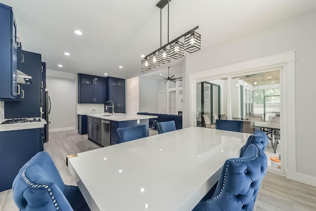 dining room featuring a ceiling fan, baseboards, recessed lighting, and light wood-type flooring