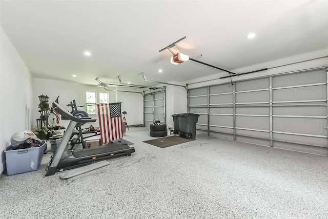 garage with recessed lighting and a garage door opener