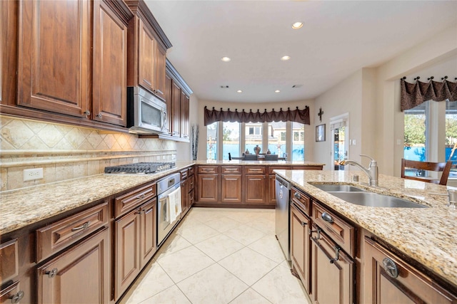 28202 Rippling Brook Ln, Fulshear, TX 77441 - kitchen featuring recessed lighting, a sink, appliances with stainless steel finishes, and light stone counters