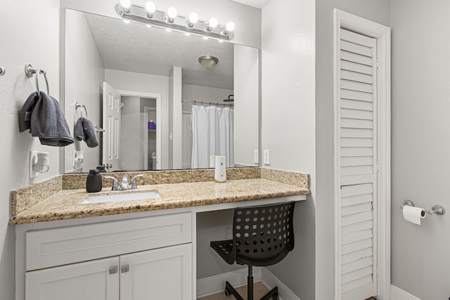 full bathroom with vanity, baseboards, and curtained shower