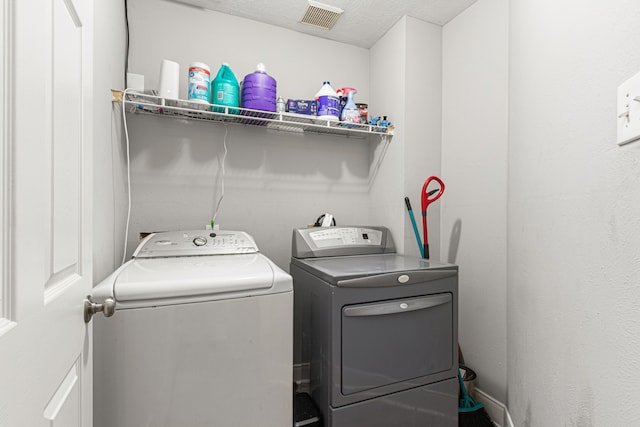 laundry area with washer and dryer, laundry area, and visible vents