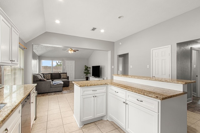 kitchen featuring ceiling fan, visible vents, stainless steel dishwasher, vaulted ceiling, and white cabinetry