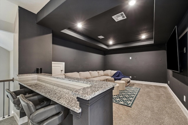 carpeted home theater room with recessed lighting, baseboards, visible vents, and a raised ceiling