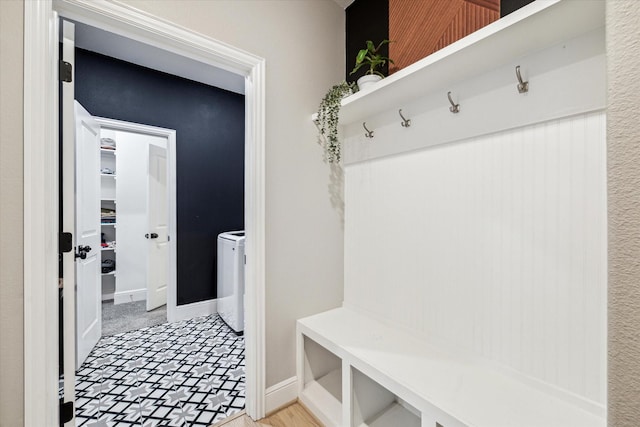mudroom featuring baseboards and washer / dryer