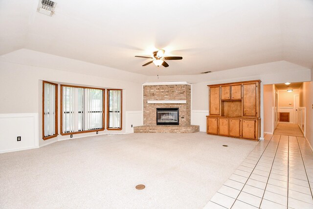 406 Hidden Creek Cir, Sealy, TX 77474 - unfurnished living room featuring ceiling fan, lofted ceiling, a fireplace, light carpet, and light tile patterned flooring