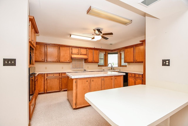 406 Hidden Creek Cir, Sealy, TX 77474 - kitchen with oven, light countertops, a center island, a ceiling fan, and a sink