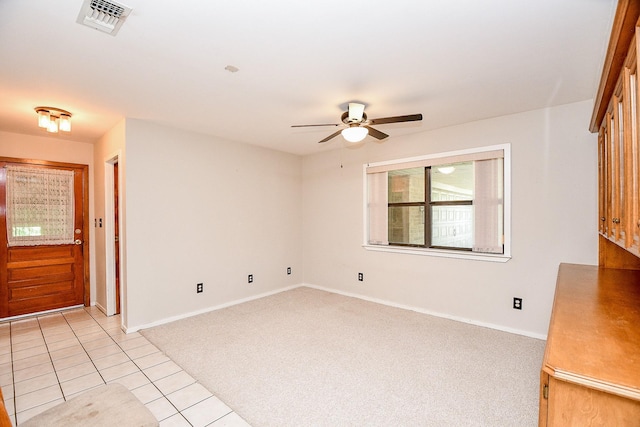 406 Hidden Creek Cir, Sealy, TX 77474 - empty room with a ceiling fan, light carpet, baseboards, and light tile patterned floors