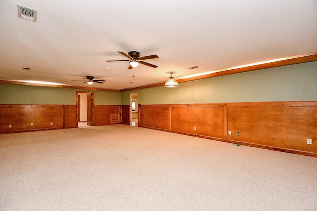 406 Hidden Creek Cir, Sealy, TX 77474 - carpeted empty room featuring a wainscoted wall, a ceiling fan, and crown molding