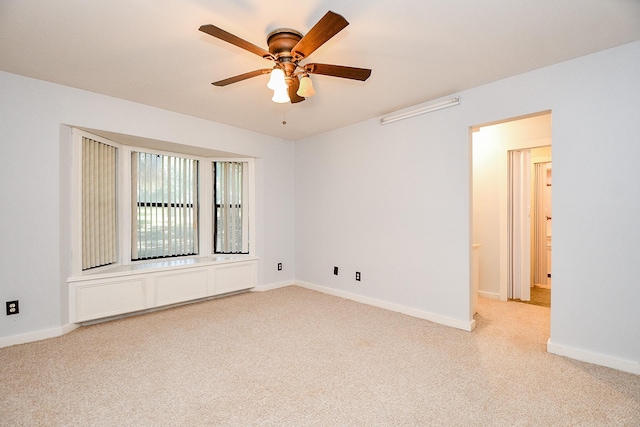 406 Hidden Creek Cir, Sealy, TX 77474 - spare room with light colored carpet, a ceiling fan, and baseboards
