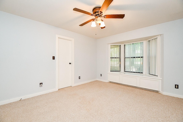 406 Hidden Creek Cir, Sealy, TX 77474 - spare room featuring light carpet, a ceiling fan, and baseboards