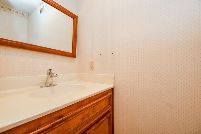 406 Hidden Creek Cir, Sealy, TX 77474 - bathroom featuring wallpapered walls and vanity