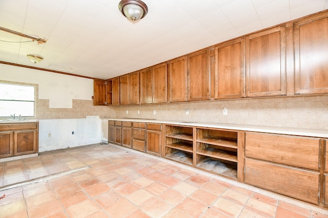 406 Hidden Creek Cir, Sealy, TX 77474 - kitchen with brown cabinetry, light countertops, open shelves, and a sink