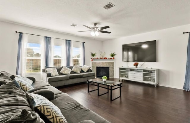 1942 Macondray Dr, Humble, TX 77396 - living area with ceiling fan, dark wood-style floors, a textured ceiling, and visible vents