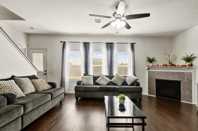 1942 Macondray Dr, Humble, TX 77396 - living area featuring ceiling fan, visible vents, a fireplace, wood finished floors, and baseboards