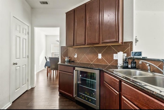 1942 Macondray Dr, Humble, TX 77396 - kitchen featuring dark countertops, beverage cooler, tasteful backsplash, visible vents, and dark wood-style floors