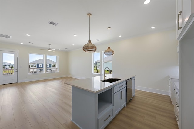 4042 Miramar Ct, Galveston, TX 77554 - kitchen featuring visible vents, a sink, light wood-style floors, and stainless steel dishwasher