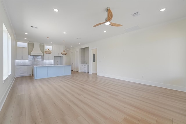 4042 Miramar Ct, Galveston, TX 77554 - unfurnished living room with visible vents, recessed lighting, crown molding, and light wood-type flooring