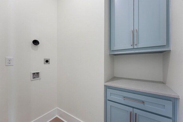 4042 Miramar Ct, Galveston, TX 77554 - laundry room with baseboards, hookup for an electric dryer, cabinet space, and hookup for a washing machine