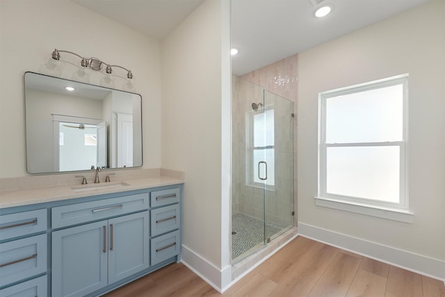 4042 Miramar Ct, Galveston, TX 77554 - bathroom featuring baseboards, a shower stall, wood finished floors, and vanity
