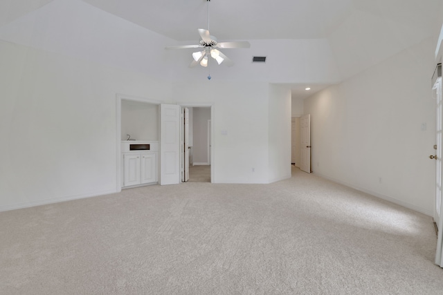 spare room featuring baseboards, ceiling fan, light colored carpet, and visible vents
