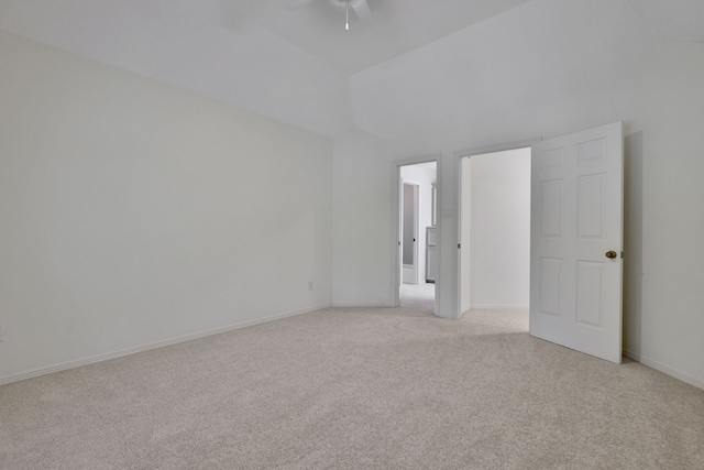 empty room featuring a ceiling fan, high vaulted ceiling, light carpet, and baseboards