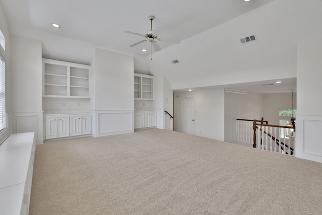 carpeted spare room with recessed lighting, ceiling fan, visible vents, and a decorative wall