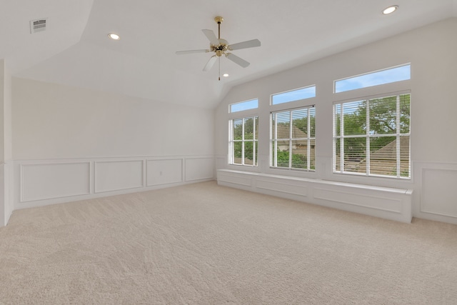 unfurnished room with light carpet, a decorative wall, a ceiling fan, recessed lighting, and visible vents