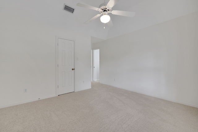 empty room featuring light colored carpet, a ceiling fan, visible vents, and baseboards