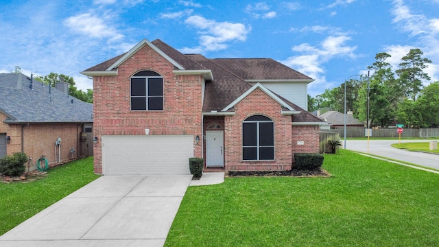traditional home with brick siding, a garage, a front yard, and concrete driveway