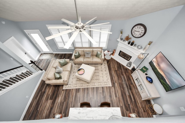 living area with ceiling fan and wood finished floors
