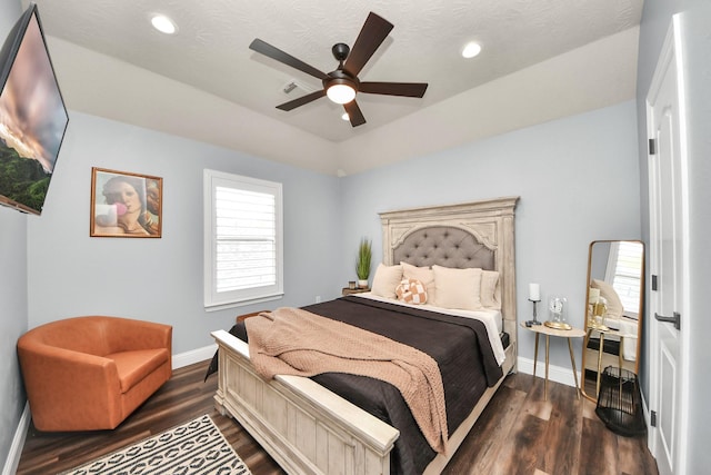 bedroom featuring dark wood-style flooring, baseboards, and multiple windows