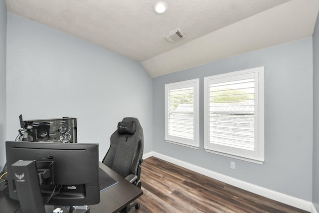 office space featuring visible vents, baseboards, lofted ceiling, and wood finished floors