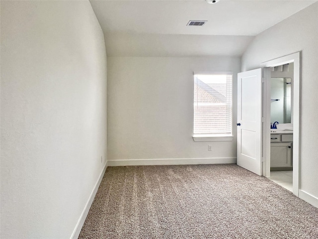 unfurnished bedroom with visible vents, baseboards, and light colored carpet