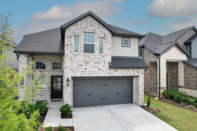 french country inspired facade with concrete driveway, a shingled roof, and a garage