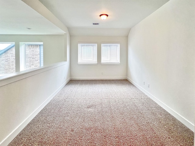 empty room with baseboards, carpet flooring, and visible vents