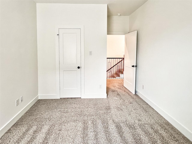 unfurnished bedroom with baseboards and carpet flooring
