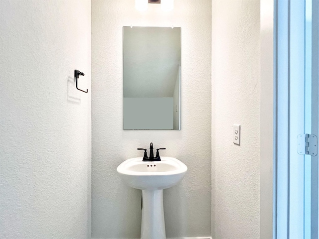 bathroom featuring a textured wall