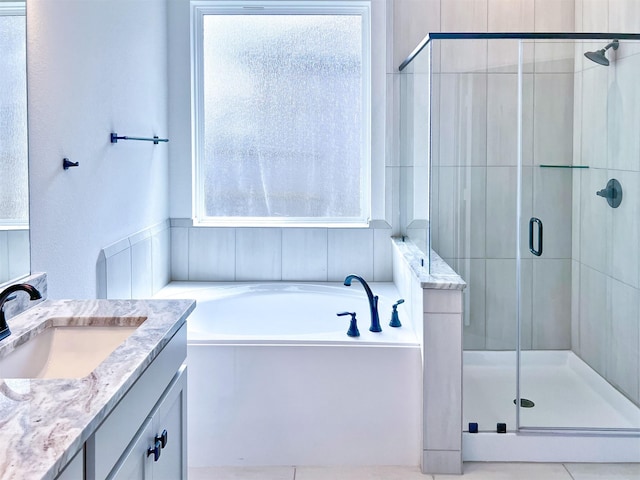 full bathroom with vanity, a stall shower, and a bath
